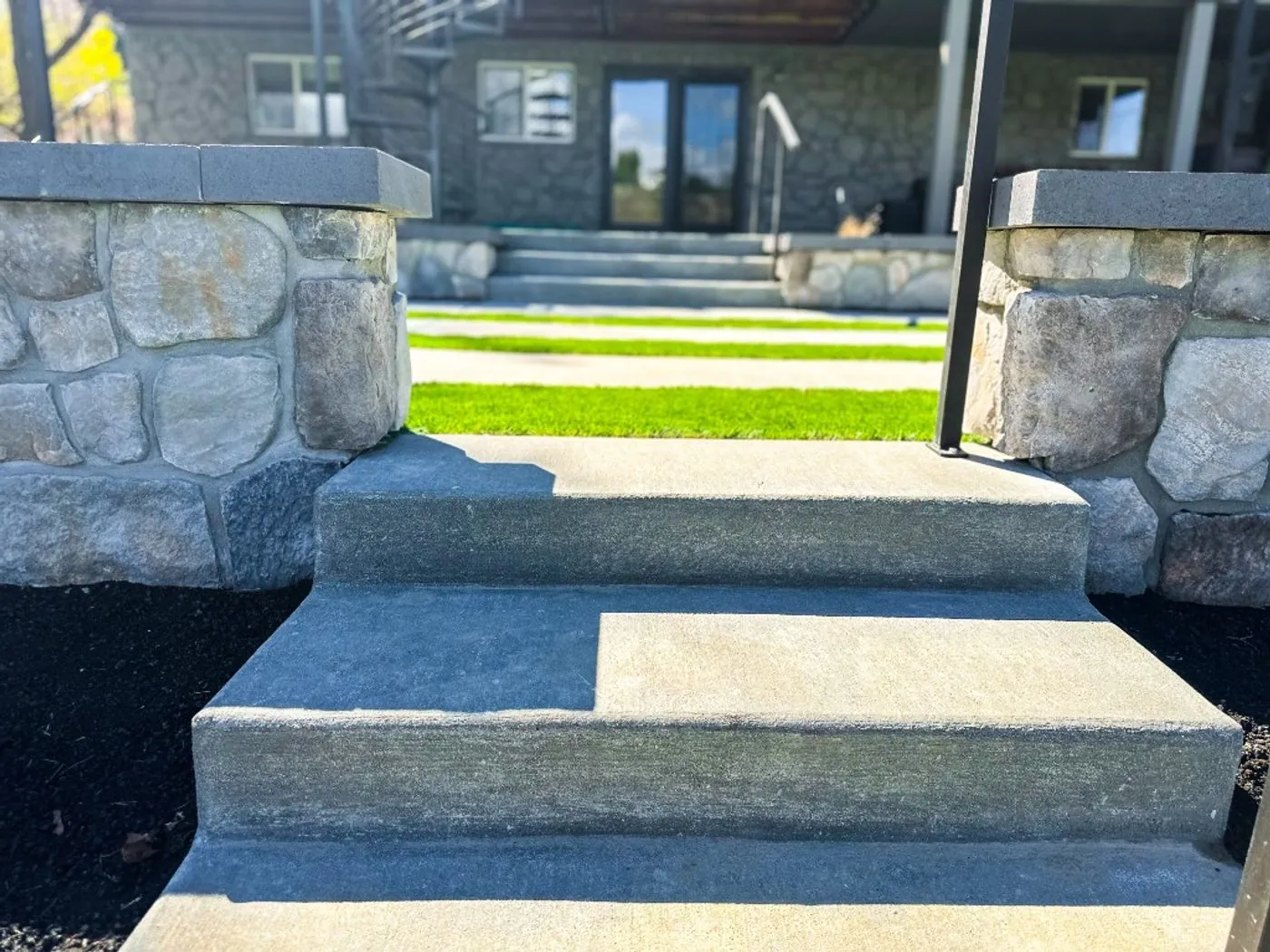 Wide concrete steps between dry-stacked stone walls