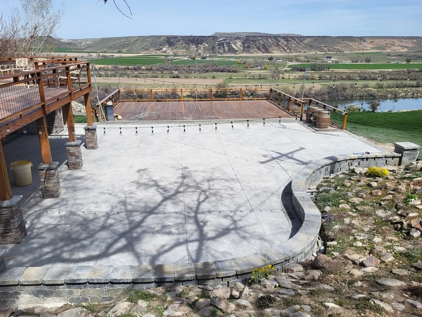 A curved concrete terrace and rock retaining wall above the Snake River valley