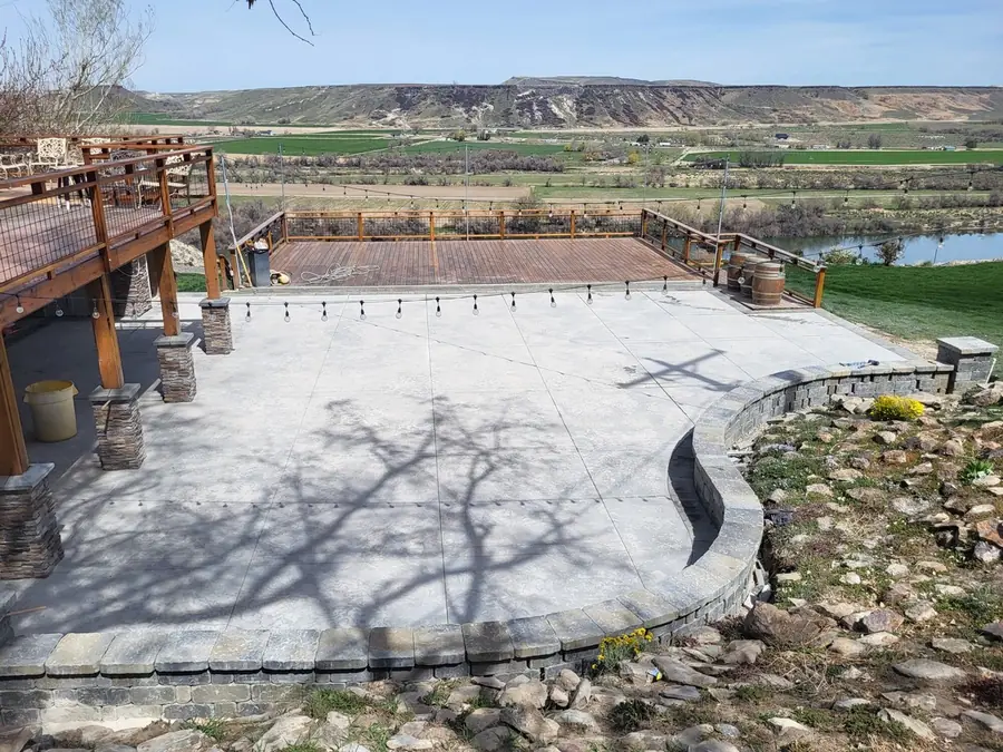 A curved concrete terrace and rock retaining wall above the Snake River valley
