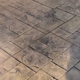 Close-up of brown stamped concrete in a slate pattern